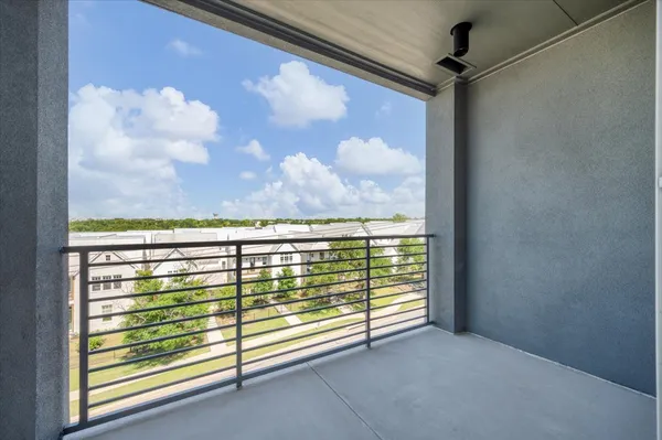 a view of a glass door with a balcony from a window