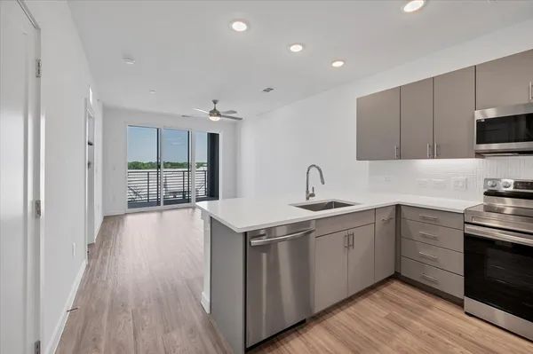 a kitchen with a sink stove and cabinets