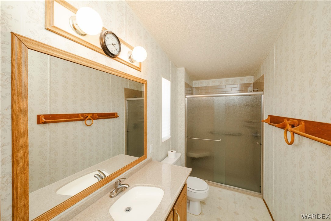 3003 Hualapai Mountain Road Kingman, AZ 86401 - Photo 20 of 49 a bathroom with a granite countertop sink toilet and shower
