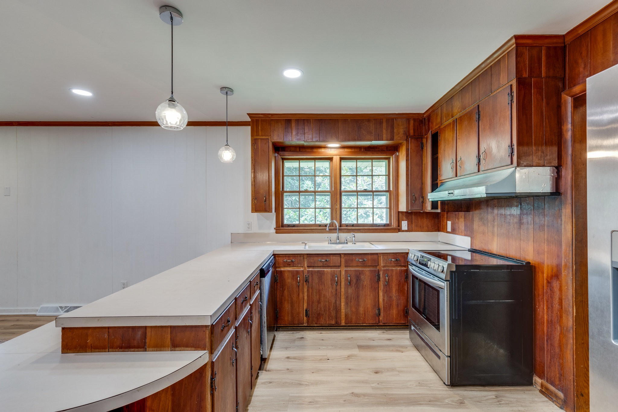 106 Sunset Drive Pulaski, TN 38478 - Photo 15 of 36 a kitchen with stainless steel appliances granite countertop a sink a stove and a wooden floors