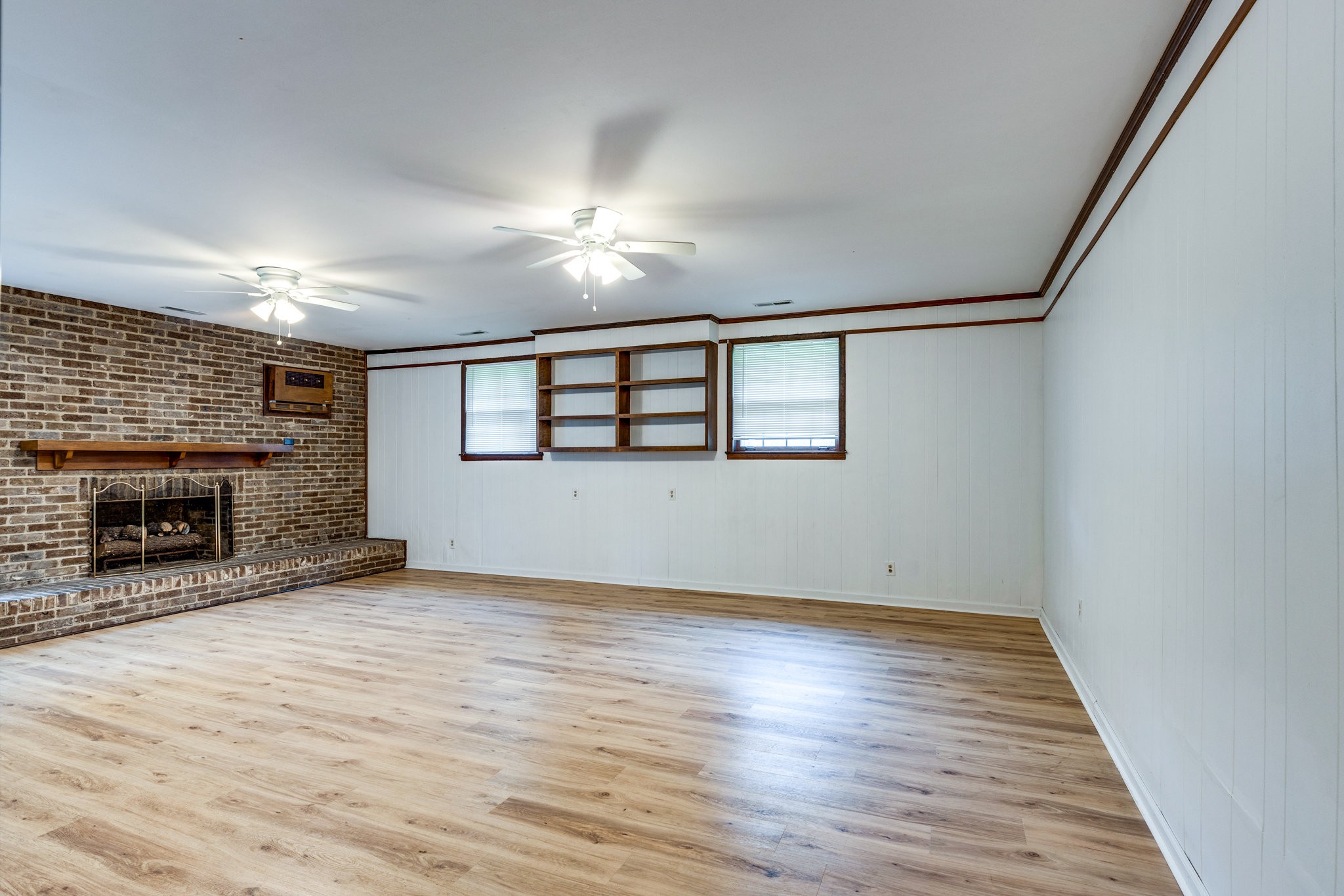 106 Sunset Drive Pulaski, TN 38478 - Photo 17 of 36 wooden floor in an empty room with a fireplace
