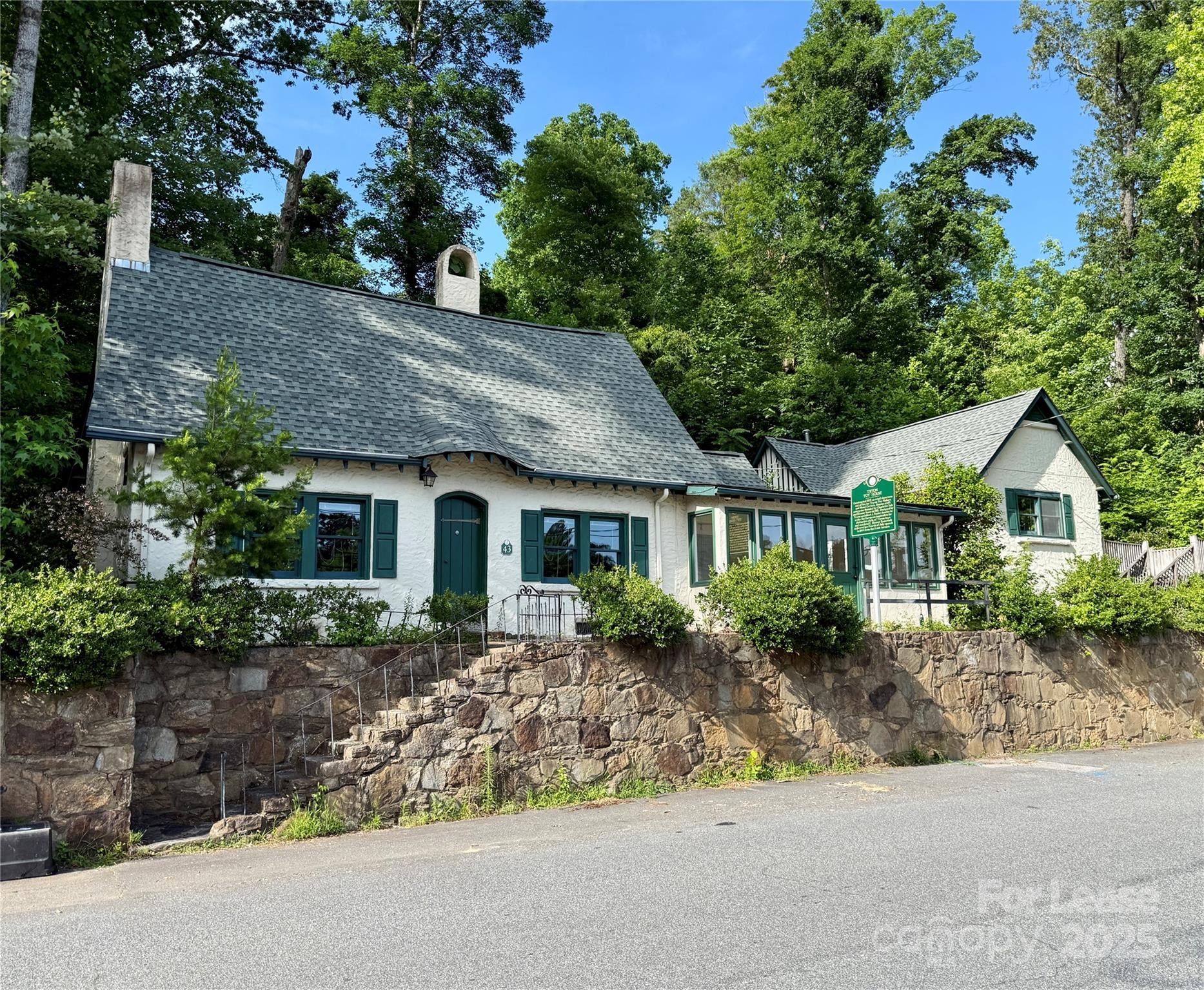 a front view of house with yard and green space