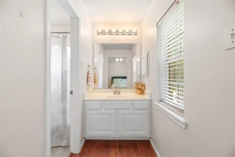 a bathroom with a sink a mirror and a window