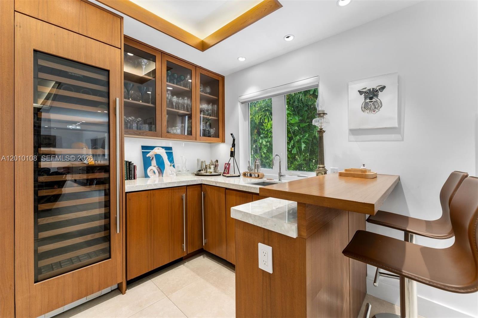 690 Warren Lane Key Biscayne, FL 33149 - Photo 13 of 39 a kitchen that has a sink and a chair in it