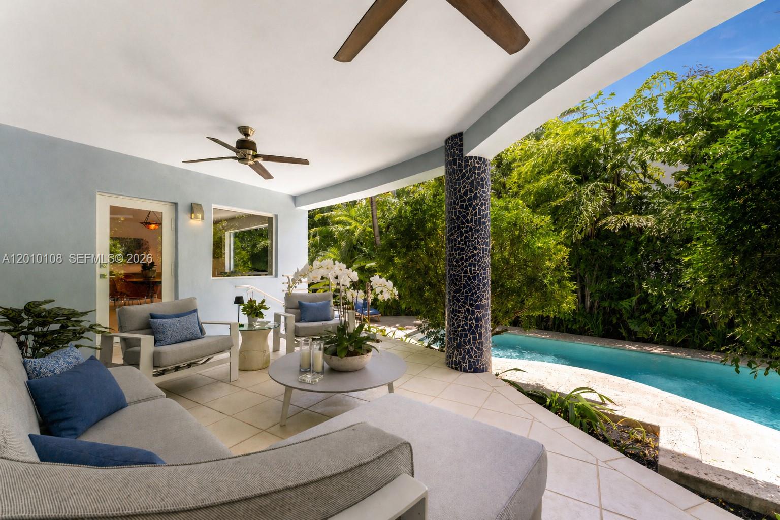 690 Warren Lane Key Biscayne, FL 33149 - Photo 16 of 39 a living room with patio furniture and a garden