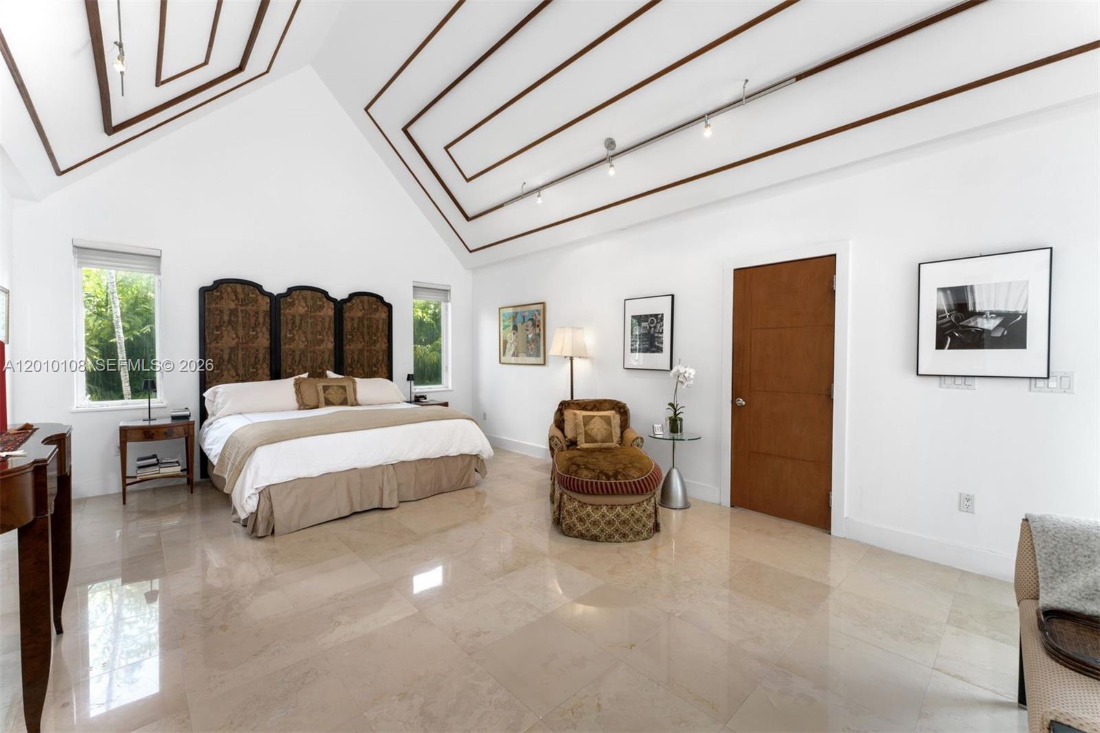690 Warren Lane Key Biscayne, FL 33149 - Photo 18 of 39 a spacious bedroom with a bed and glass door