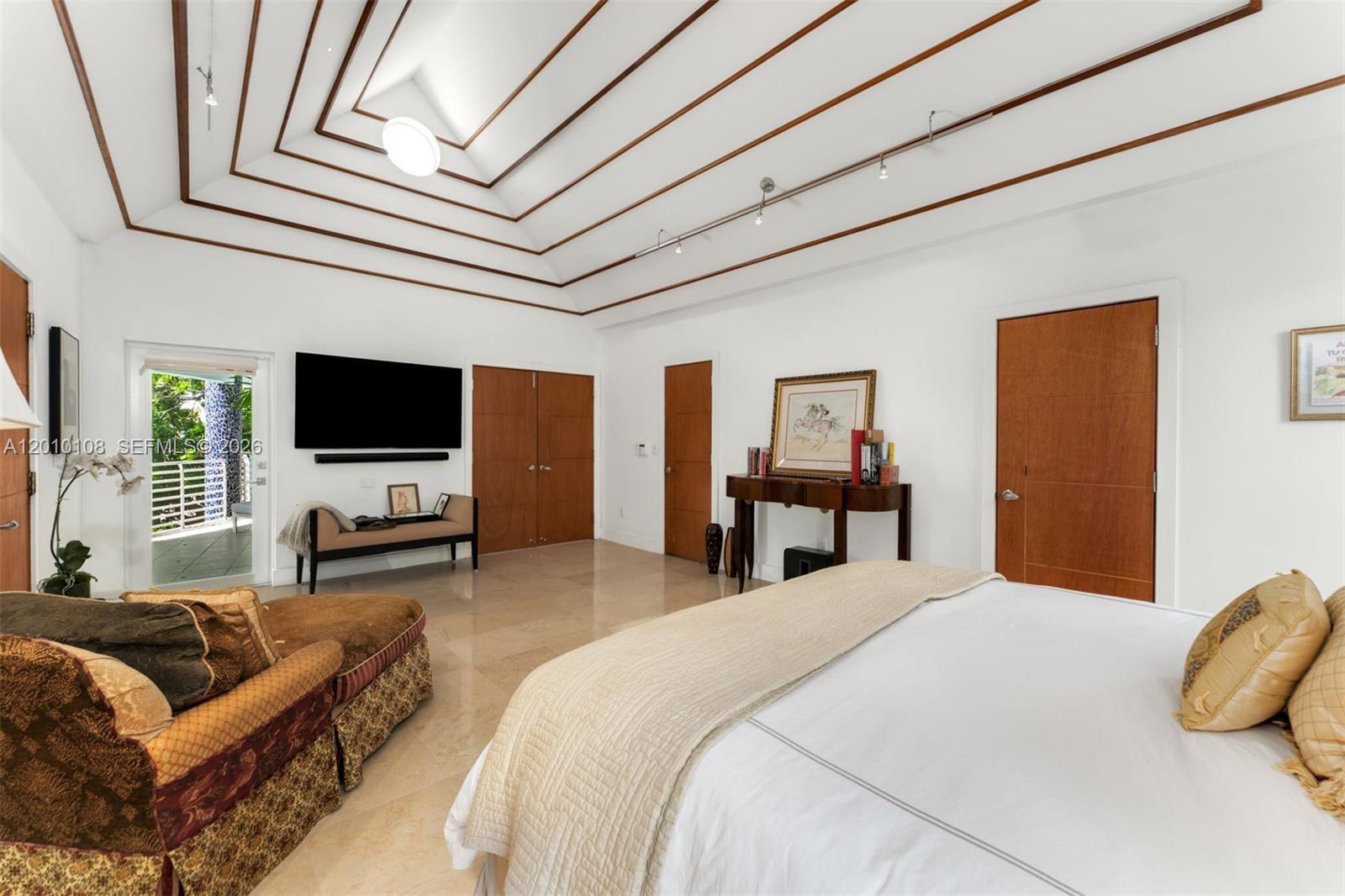 690 Warren Lane Key Biscayne, FL 33149 - Photo 19 of 39 a bedroom with bed or couch and a flat screen tv