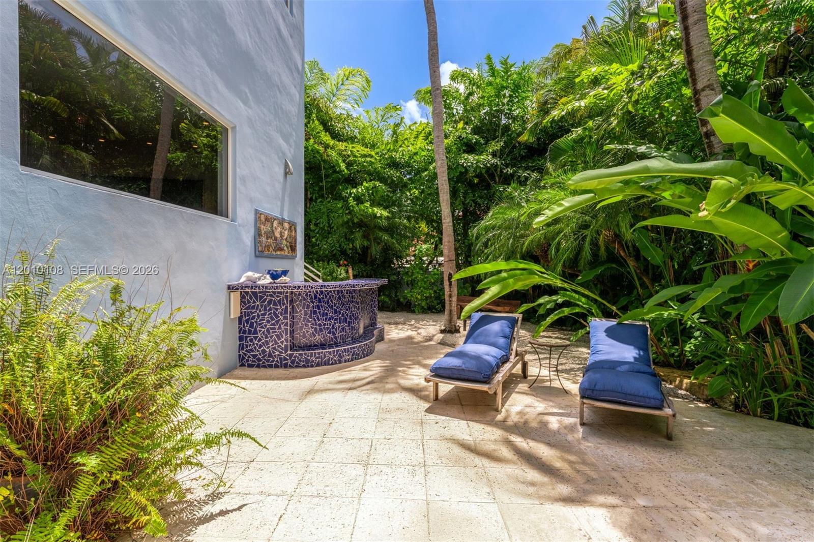 690 Warren Lane Key Biscayne, FL 33149 - Photo 35 of 39 a view of a backyard with plants and outdoor seating
