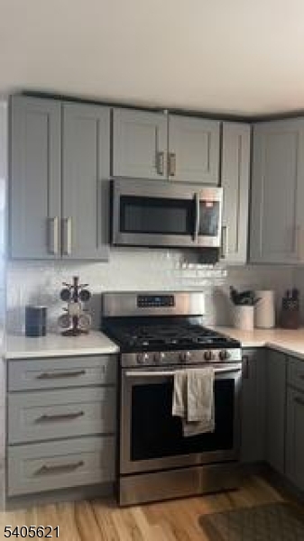 111 Pennington Street Newark, NJ 07105 - Photo 4 of 13 a kitchen with a stove and a microwave