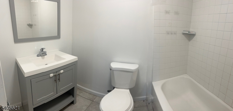 111 Pennington Street Newark, NJ 07105 - Photo 9 of 13 a bathroom with a sink a toilet and mirror