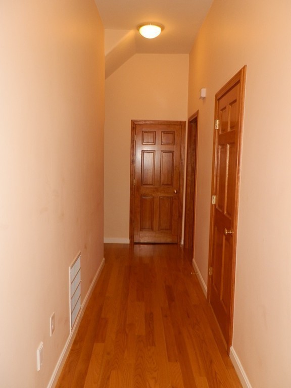 194 Auburn Street, Unit 1 Newton, MA 02466 - Photo 12 of 15 a view of hallway with wooden floor