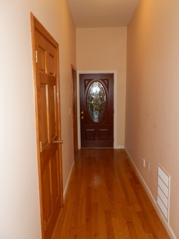 194 Auburn Street, Unit 1 Newton, MA 02466 - Photo 13 of 15 a view of hallway with wooden floor