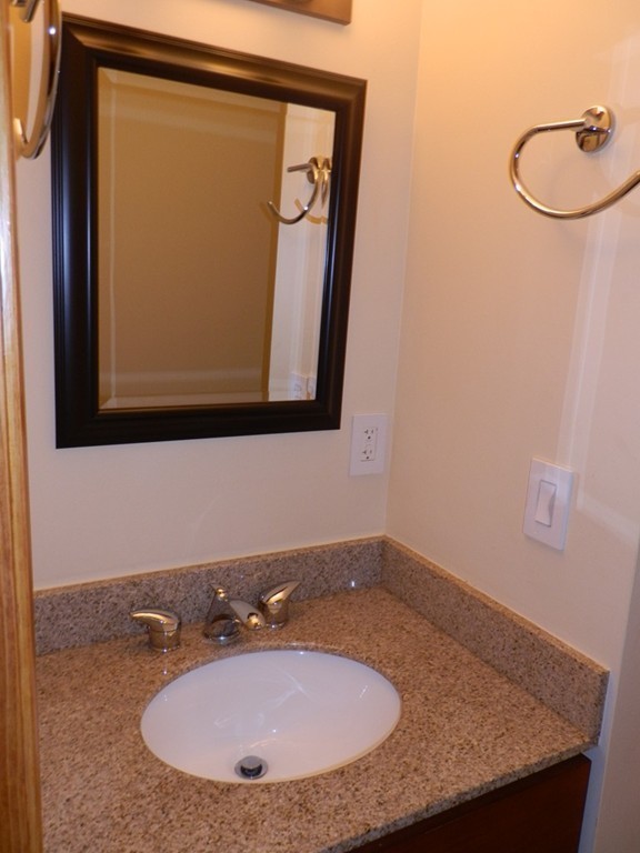194 Auburn Street, Unit 1 Newton, MA 02466 - Photo 8 of 15 a bathroom with a granite countertop sink and a mirror