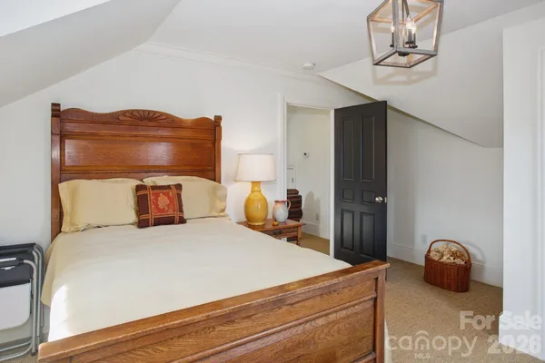a bedroom with a bed and ceiling fan