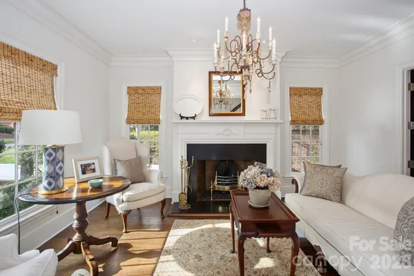 a living room with furniture and a chandelier
