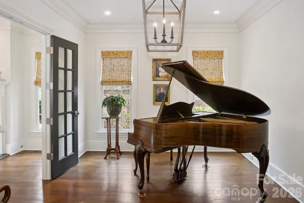a living room with furniture and a chandelier