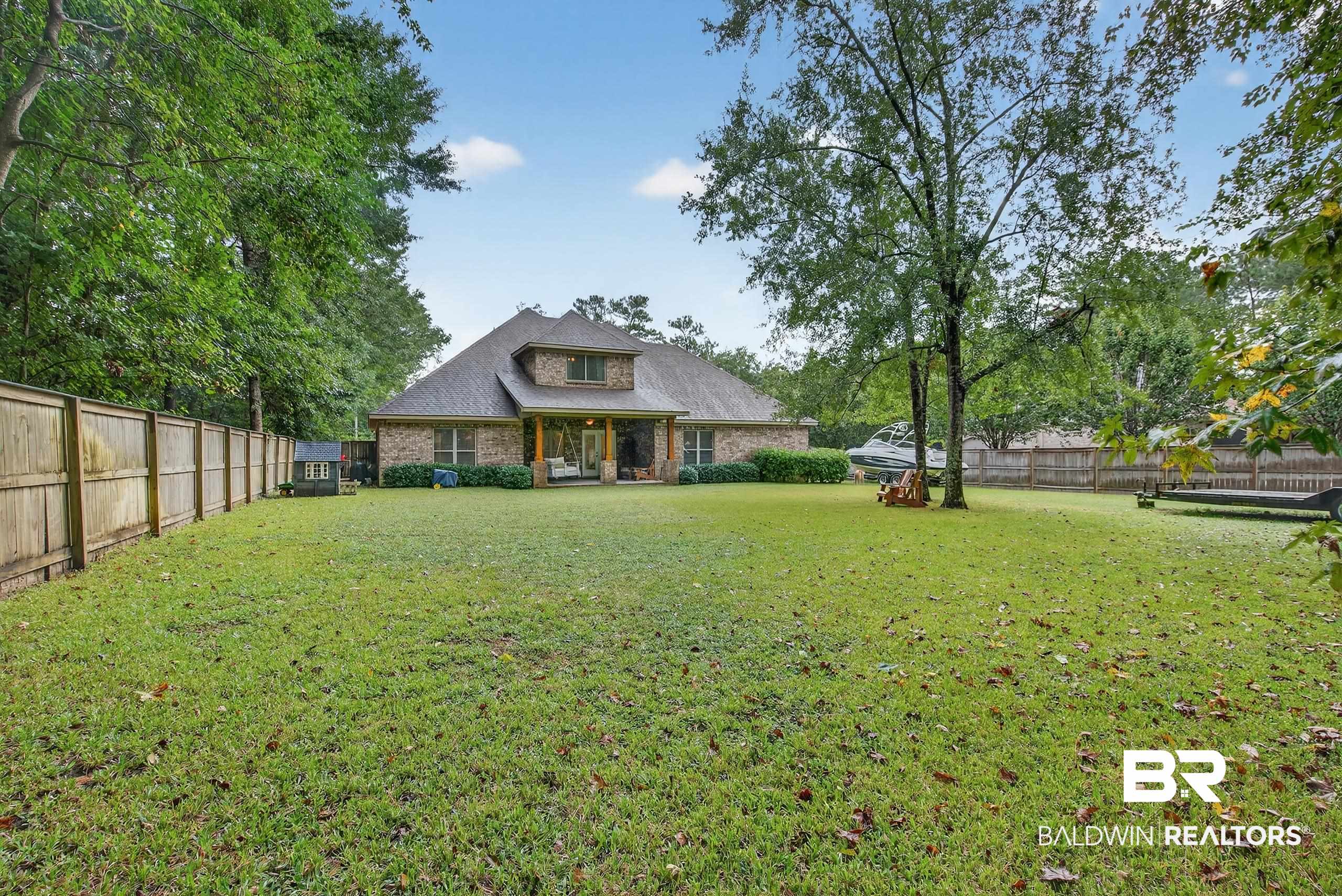 5517 Rabbit Creek Drive Theodore, AL 36582 - Photo 29 of 33 Back of property with a fenced backyard, brick siding, and a shingled roof