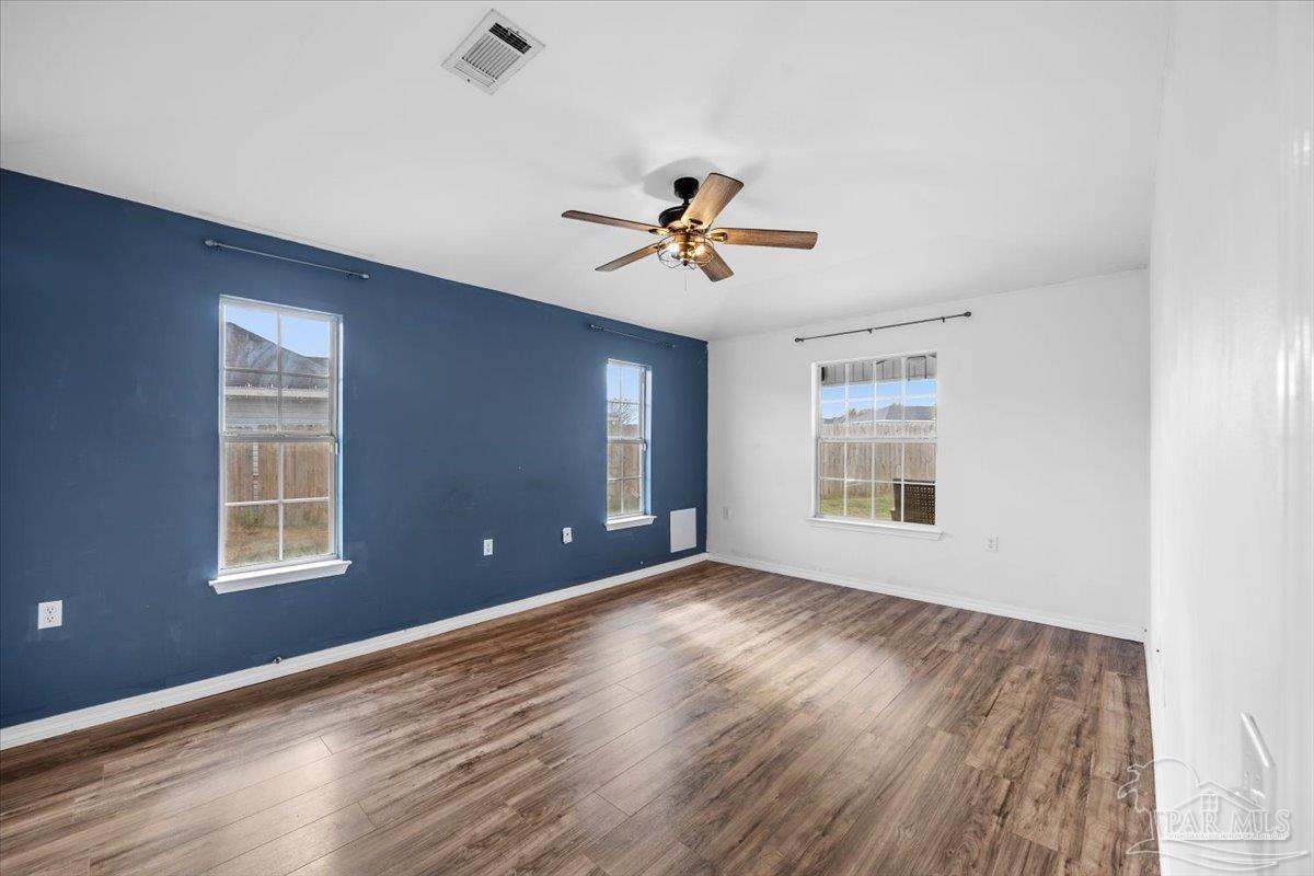 1186 Brownfield Road Pensacola, FL 32526 - Photo 12 of 20 a view of empty room with wooden floor and fan