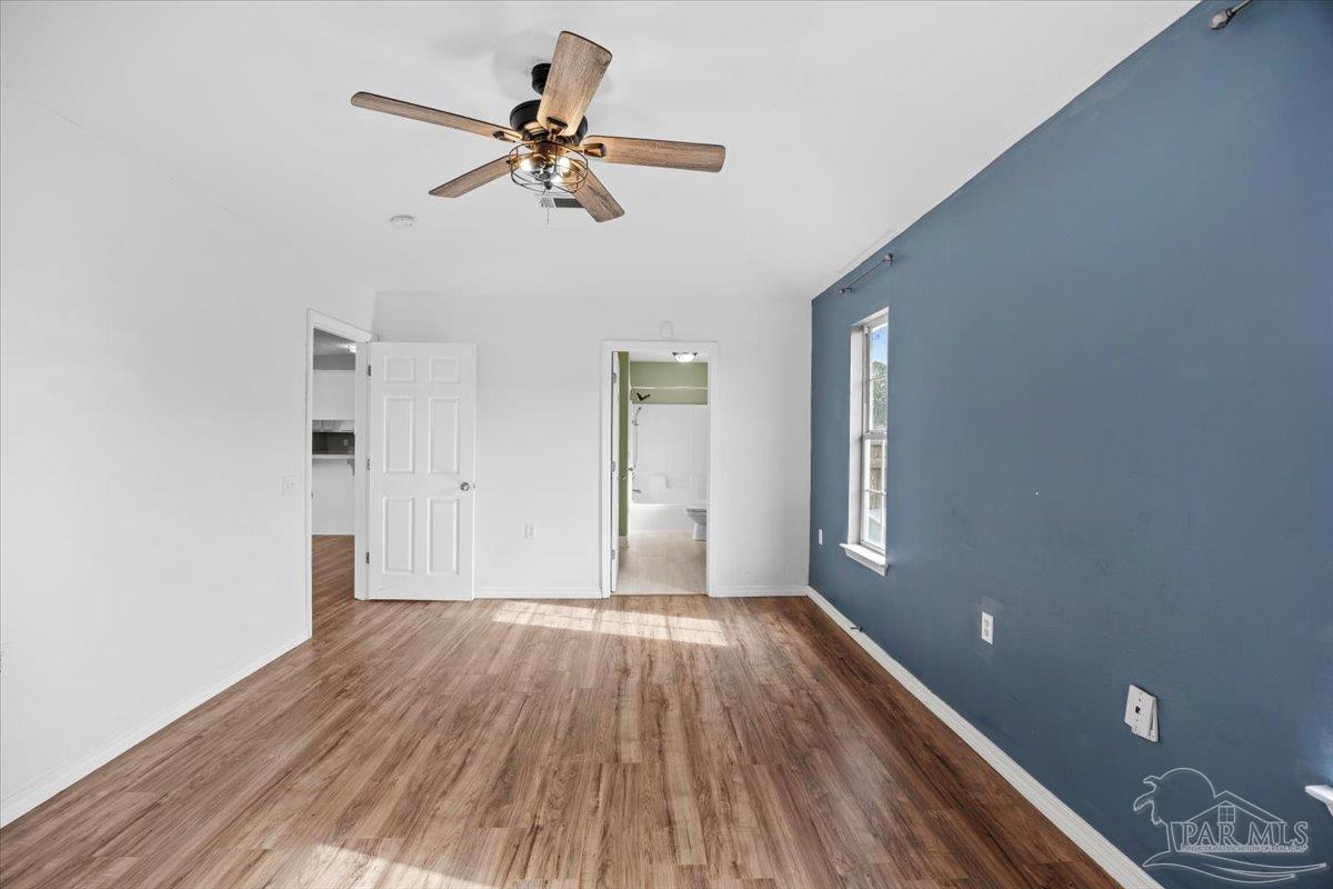 1186 Brownfield Road Pensacola, FL 32526 - Photo 13 of 20 a view of a room with wooden floor and a ceiling fan