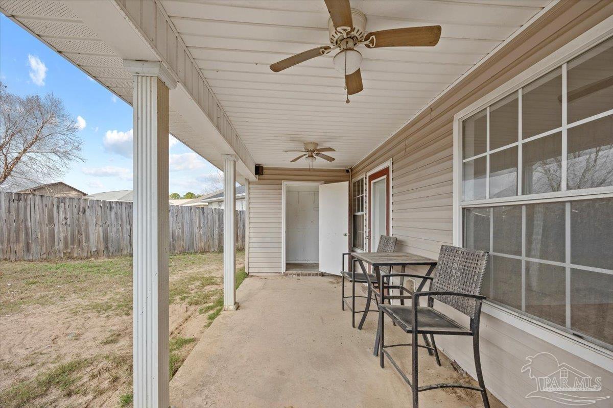 1186 Brownfield Road Pensacola, FL 32526 - Photo 19 of 20 a patio with table and chairs and potted plants