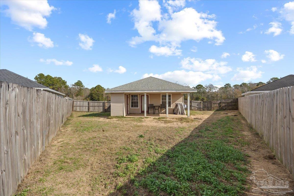 1186 Brownfield Road Pensacola, FL 32526 - Photo 20 of 20 a view of a large house with a big yard and a large tree
