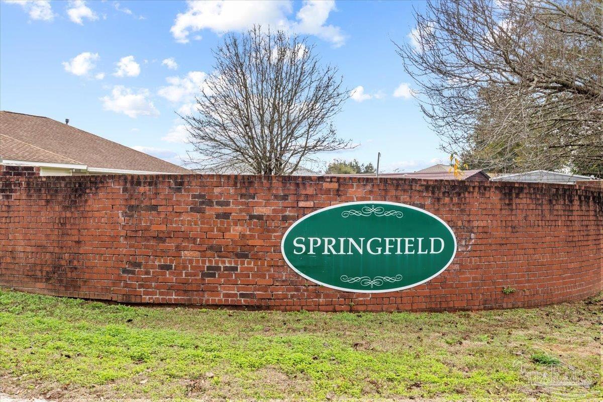 1186 Brownfield Road Pensacola, FL 32526 - Photo 2 of 20 a sign of golf club on a wall under a large tree