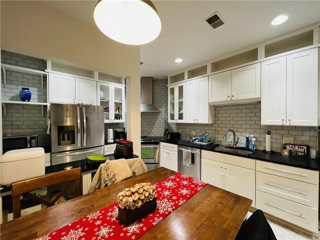 304 Rhodes Place New Castle, PA 16101 - Photo 17 of 31 a kitchen with granite countertop a sink dishwasher stove and cabinets