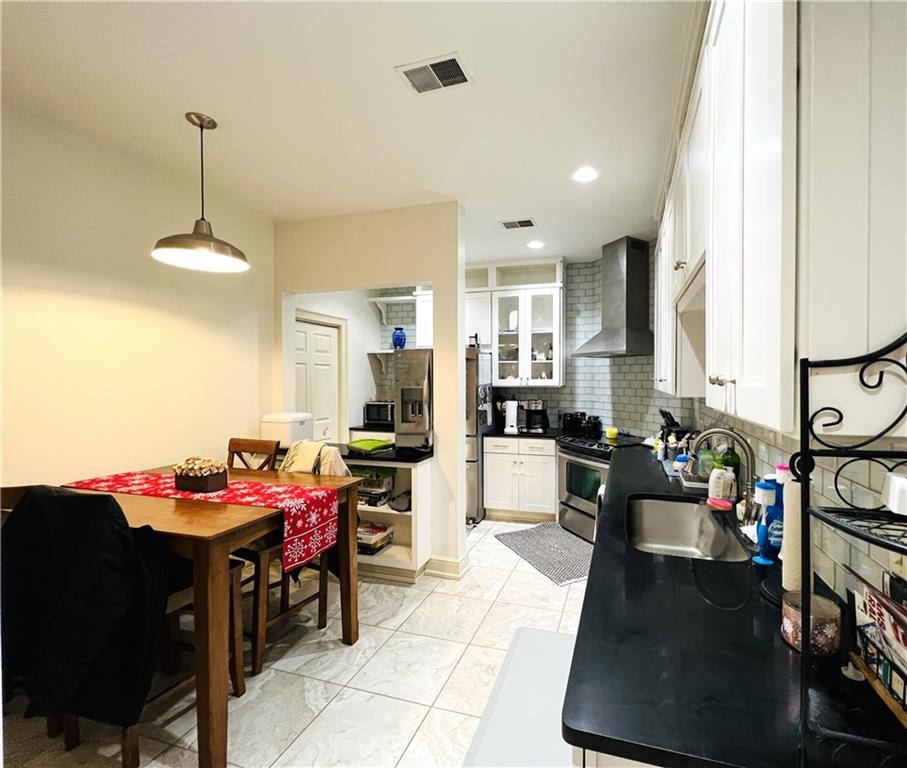 304 Rhodes Place New Castle, PA 16101 - Photo 18 of 31 a kitchen with a dining table chairs workspace and a window