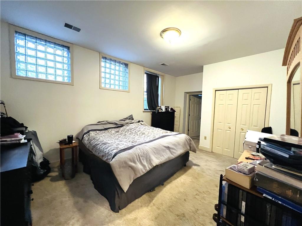 304 Rhodes Place New Castle, PA 16101 - Photo 20 of 31 a spacious bedroom with a bed and a dresser