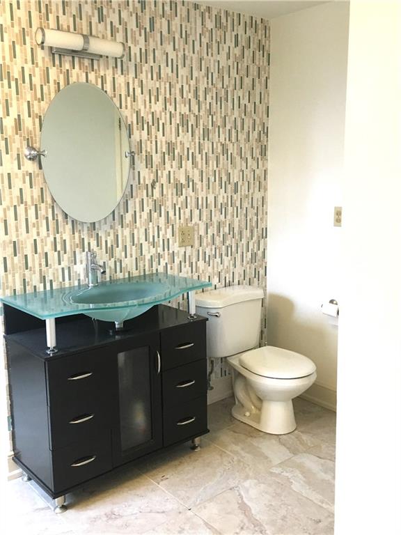304 Rhodes Place New Castle, PA 16101 - Photo 24 of 31 a bathroom with a toilet a sink and mirror