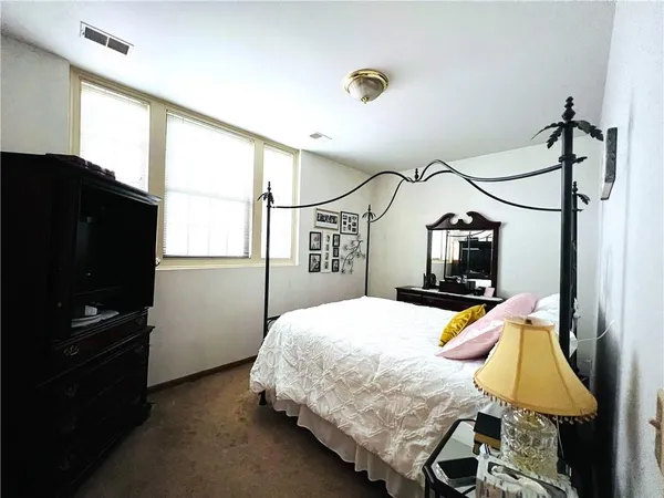 a bedroom with bed and wooden floor
