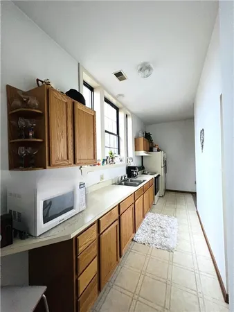 a large kitchen with stainless steel appliances kitchen island granite countertop a sink and cabinets