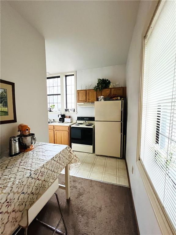304 Rhodes Place New Castle, PA 16101 - Photo 28 of 31 a kitchen with a refrigerator and a stove top oven