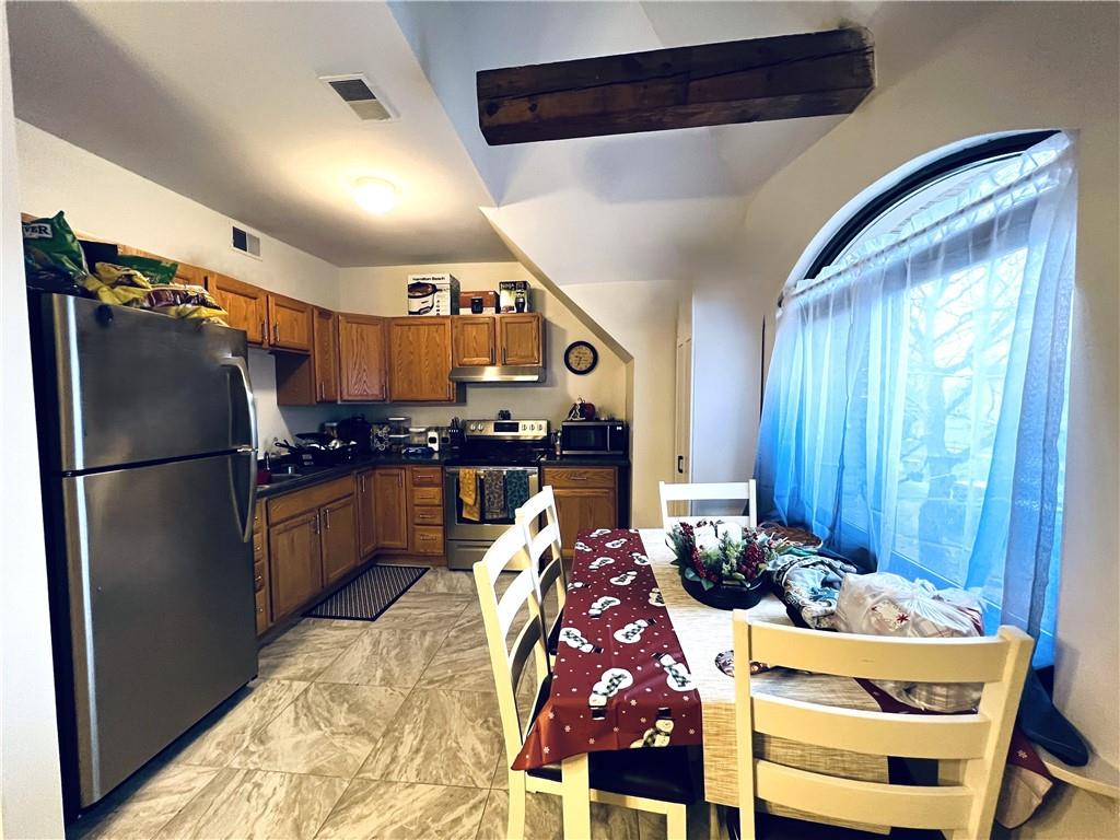 304 Rhodes Place New Castle, PA 16101 - Photo 9 of 31 a kitchen with stainless steel appliances granite countertop a refrigerator and a stove top oven