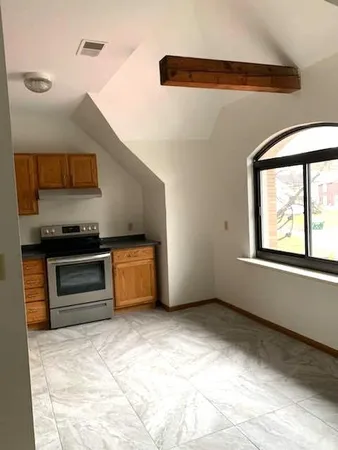 a kitchen with stainless steel appliances kitchen island granite countertop a stove and a sink with granite countertops