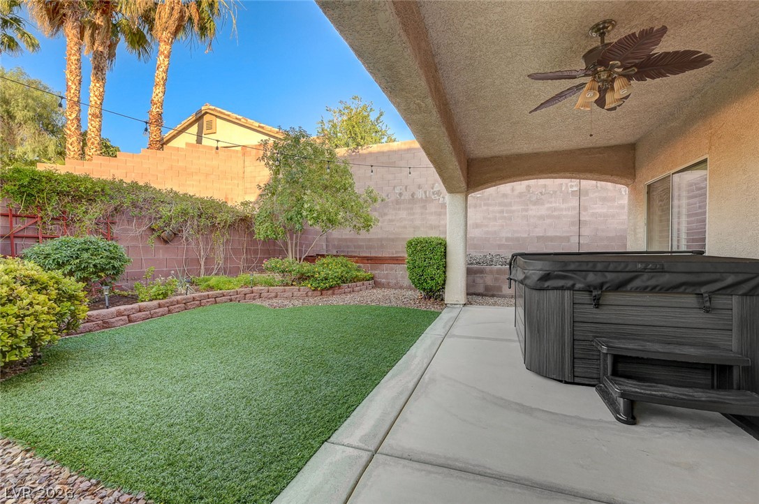 1604 Cattle Ranch Place Henderson, NV 89002 - Photo 72 of 99 An inviting backyard oasis offers a covered patio with spa and meticulously maintained landscaping.