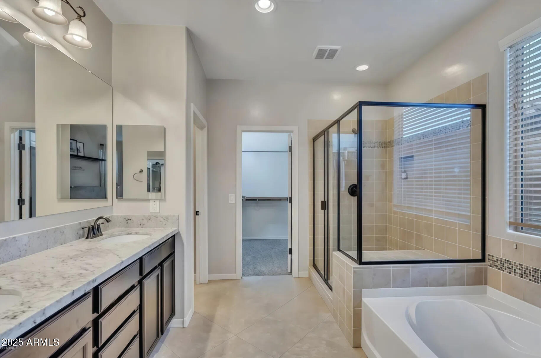 7538 West Redbird Road Peoria, AZ 85383 - Photo 11 of 24 a bathroom with a granite countertop sink mirror and a bathtub