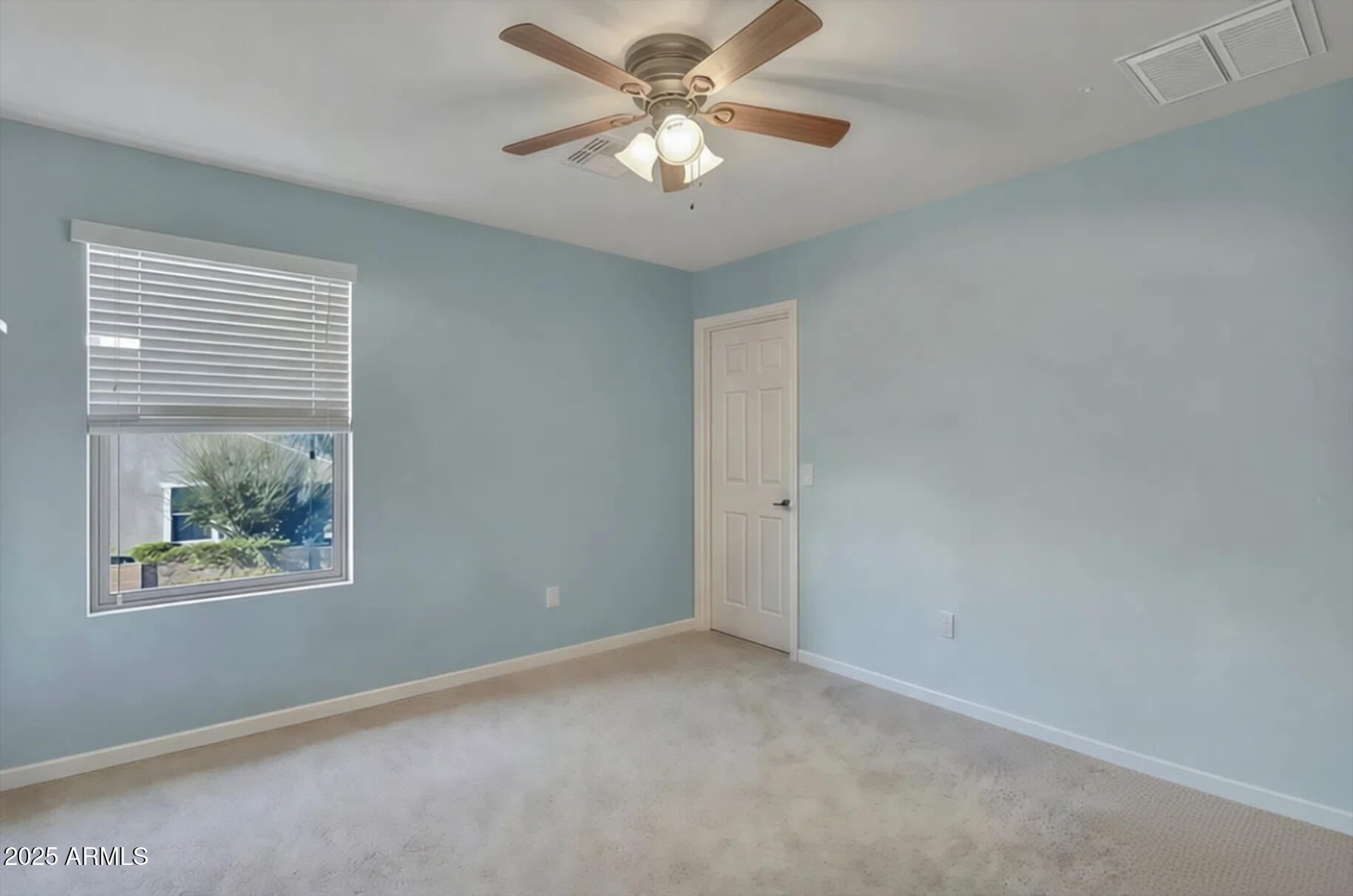 7538 West Redbird Road Peoria, AZ 85383 - Photo 18 of 24 a view of an empty room with a window