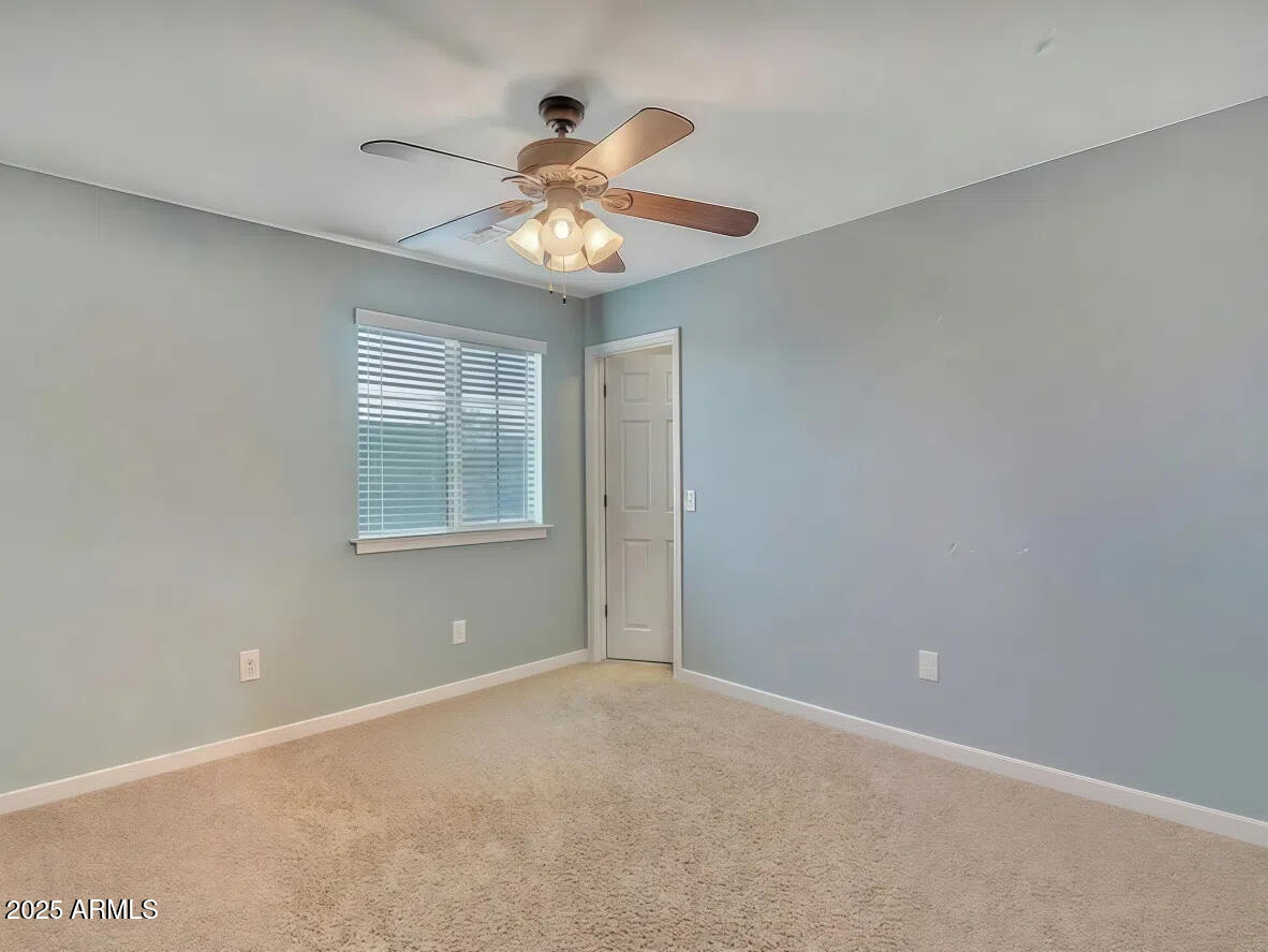 7538 West Redbird Road Peoria, AZ 85383 - Photo 20 of 24 a view of an empty room with a window