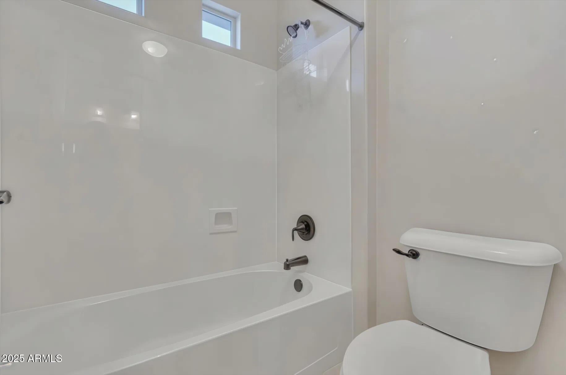 7538 West Redbird Road Peoria, AZ 85383 - Photo 21 of 24 a white toilet sitting next to a bath tub