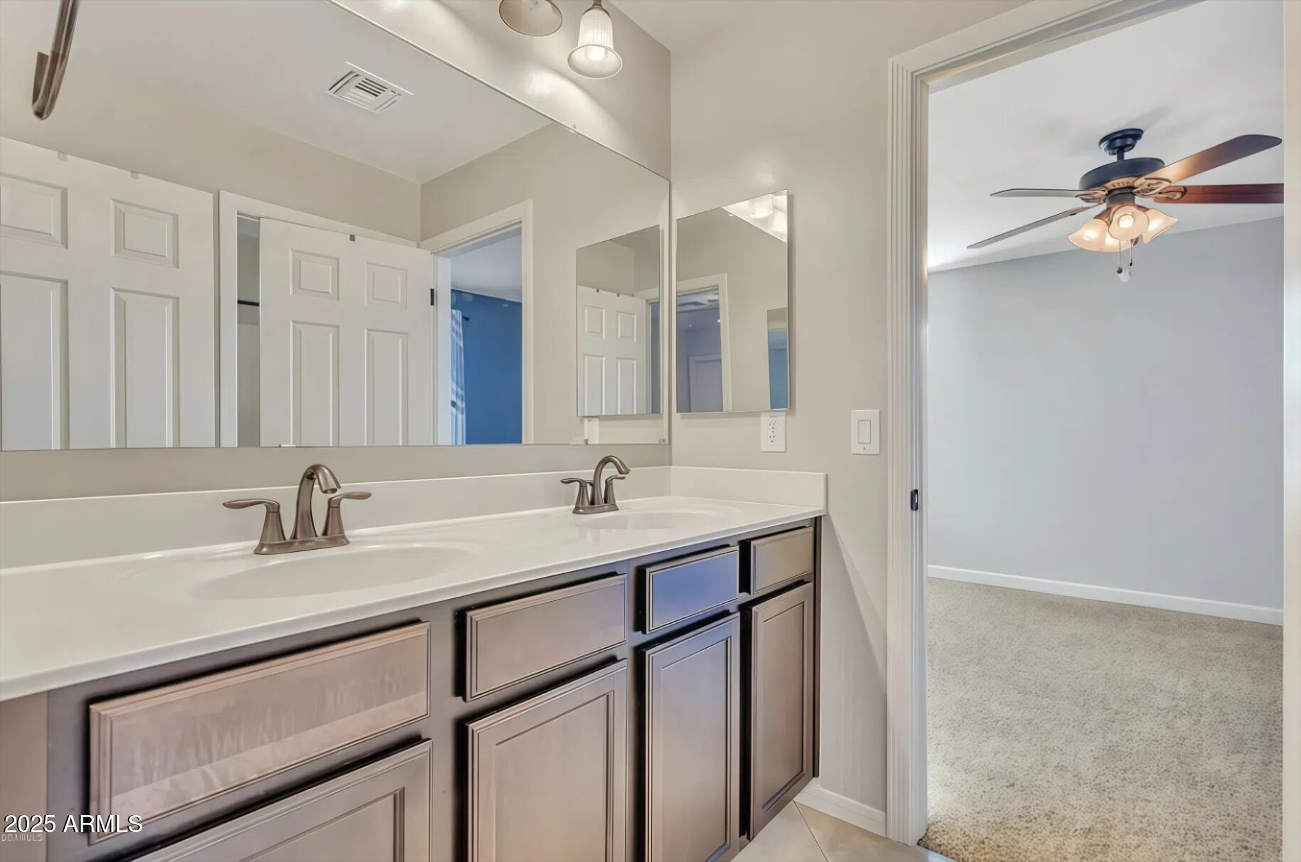 7538 West Redbird Road Peoria, AZ 85383 - Photo 22 of 24 a bathroom with a sink a vanity and a mirror