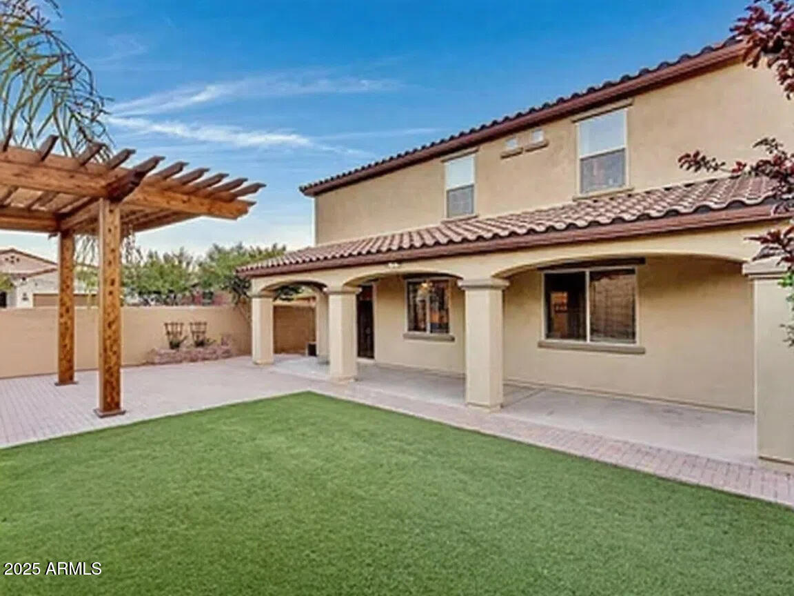 7538 West Redbird Road Peoria, AZ 85383 - Photo 24 of 24 a front view of a house with a yard and garage