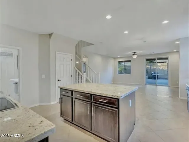 a kitchen with stainless steel appliances granite countertop a sink and a stove