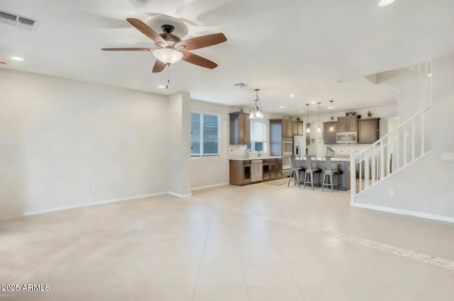7538 West Redbird Road Peoria, AZ 85383 - Photo 6 of 24 a view of a livingroom with a kitchen