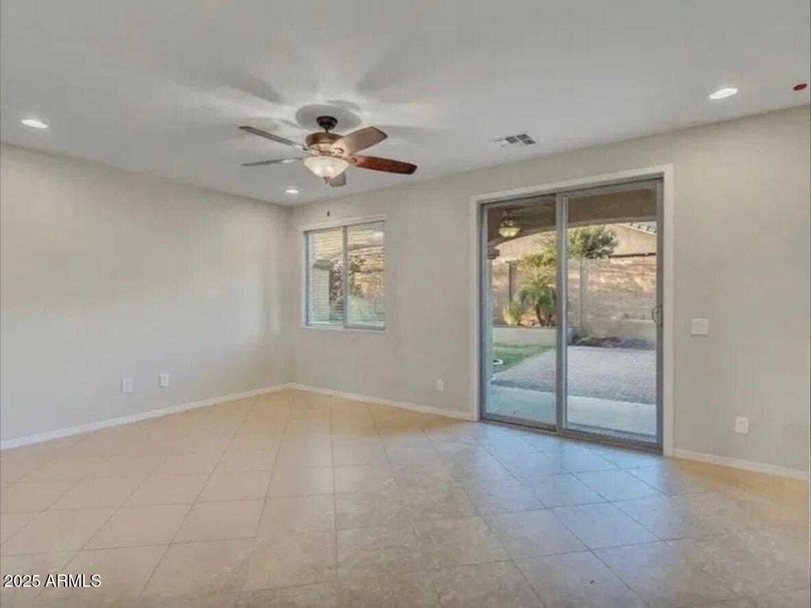7538 West Redbird Road Peoria, AZ 85383 - Photo 7 of 24 an empty room with fan and windows