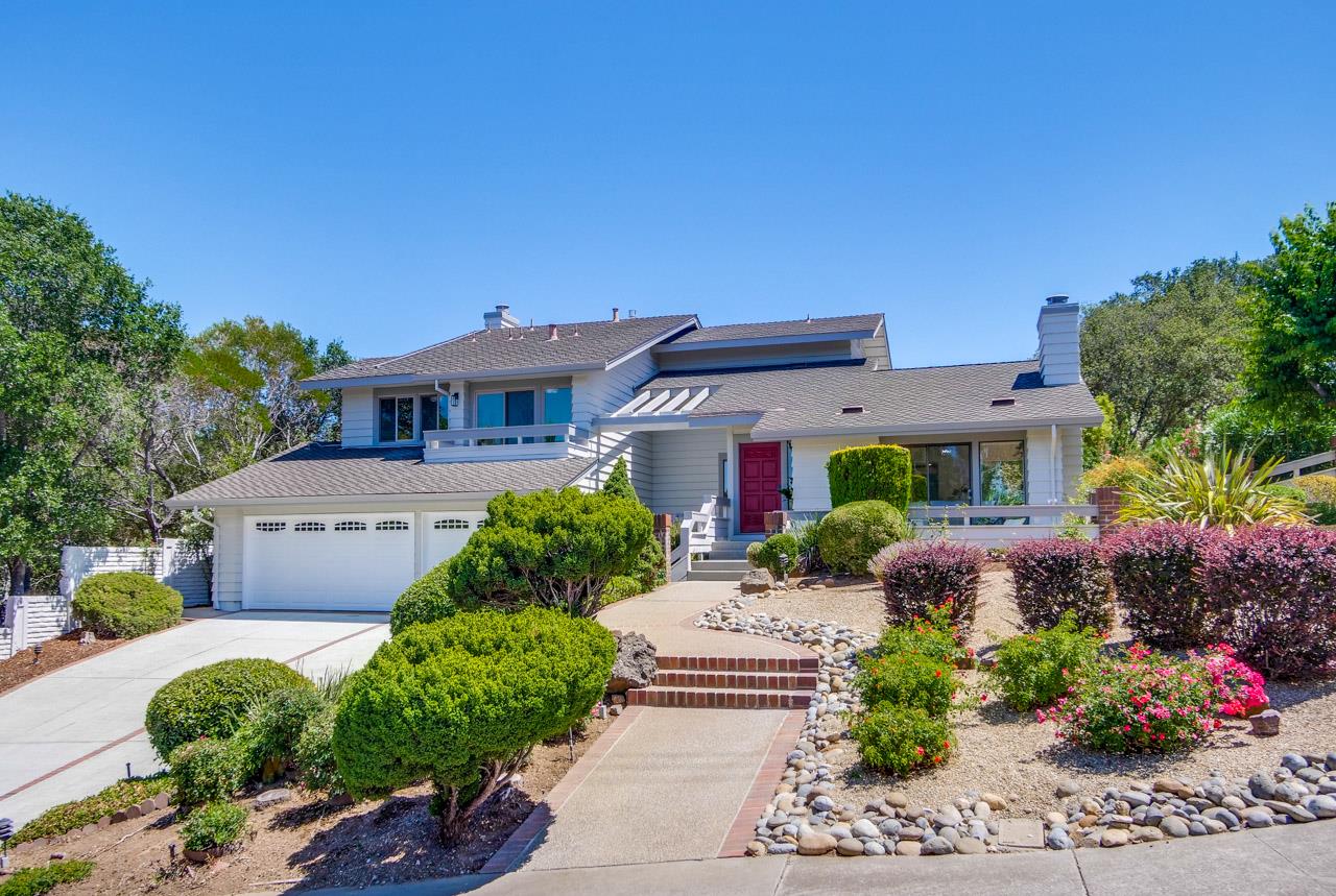 a front view of a house with a garden