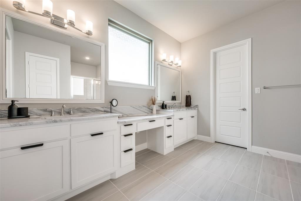 16564 Creek Plum Road Frisco, TX 75033 - Photo 12 of 30 Bathroom featuring double vanity, a shower with shower door, and light tile patterned floors