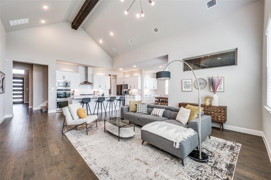 16564 Creek Plum Road Frisco, TX 75033 - Photo 5 of 30 Living room with dark wood-style floors and suspended lighting