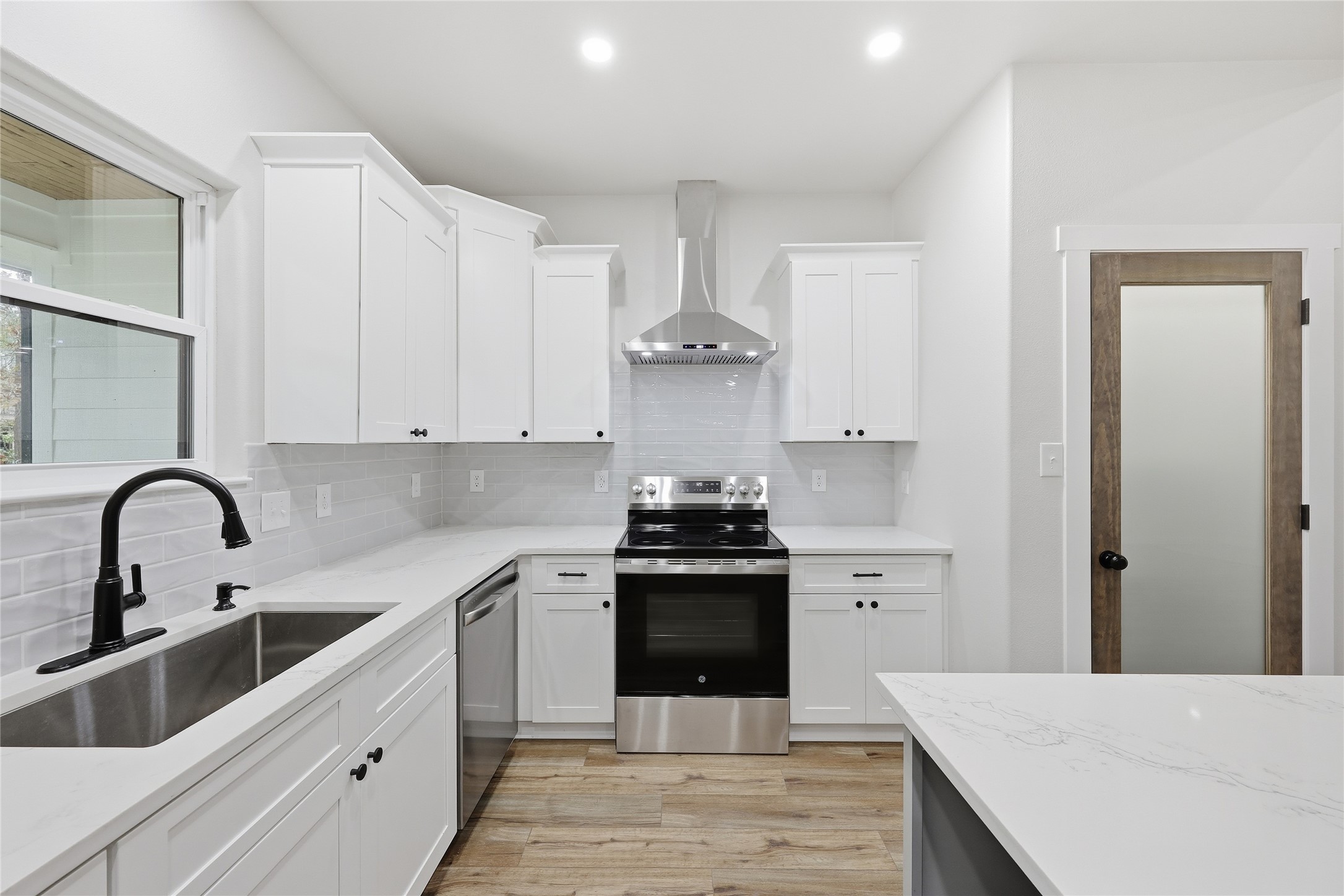 235 Dogwood Road Brookeland, TX 75931 - Photo 11 of 35 a kitchen with granite countertop a stove sink and cabinets