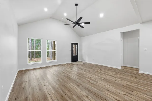 a kitchen with a stove cabinets and wooden floor